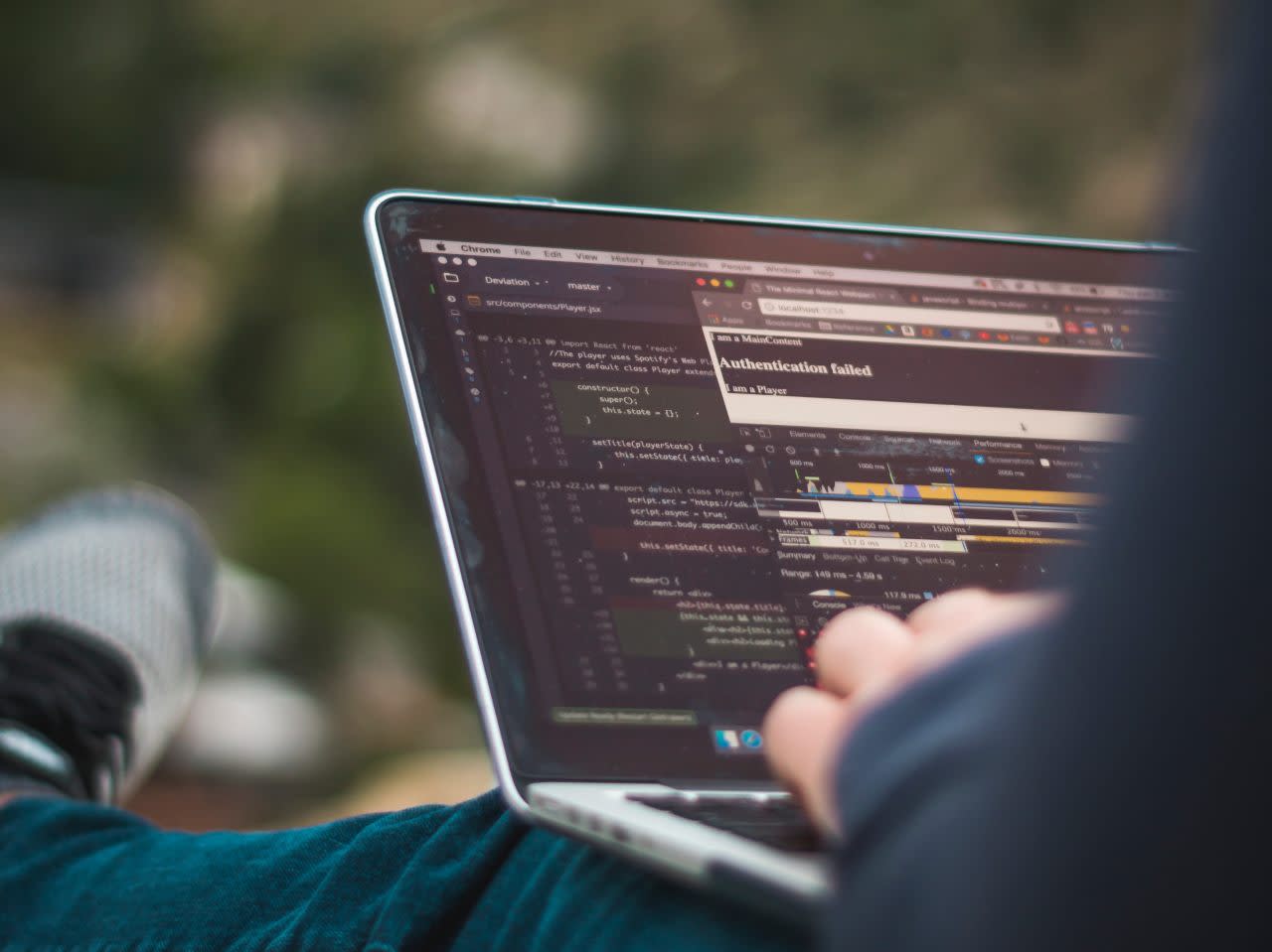 A person working on a laptop computer out in nature