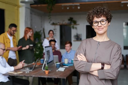 A group of happy coworkers working around a desk in an office