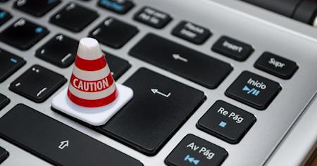 A computer keyboard with a Caution warning.