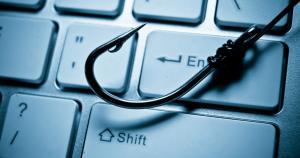 Fish hook on a keyboard representing phishing cyber attacks