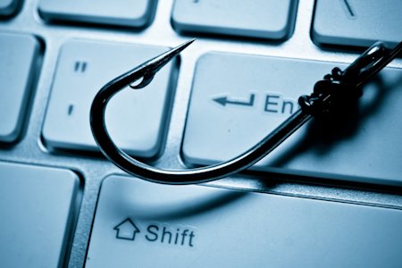 Fish hook on a keyboard representing phishing cyber attacks