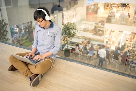 Man working on a laptop in a public space using Splashtop