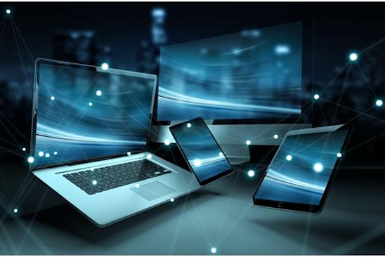 Photo of several laptops, phones, and tablets