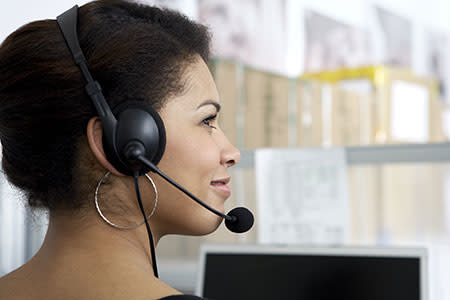 Customer service representative with a headset assisting clients through Splashtop's support solutions