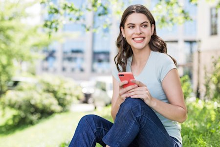 Female outdoors enjoying Splashtop Classroom with mobile phone