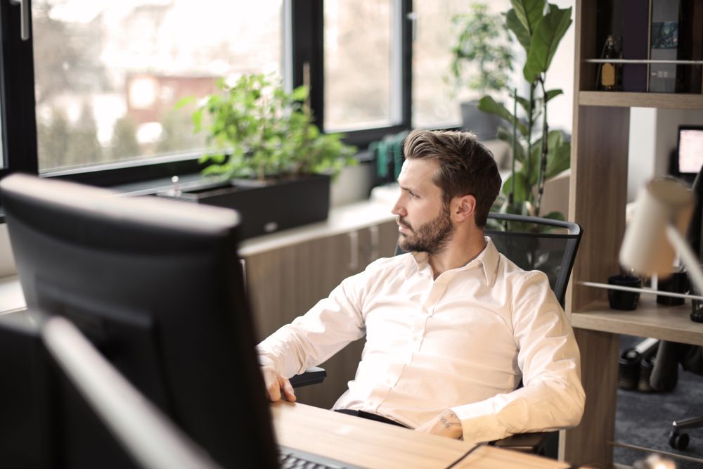 A person working on a computer in an office.