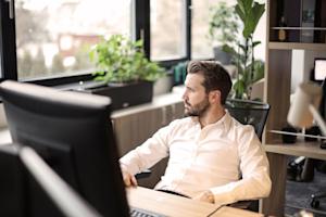 A person working on a computer in an office.