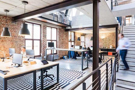 An office with several desks and computers.