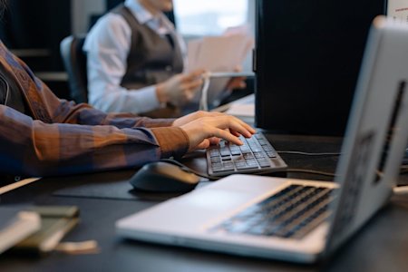 A person working on a computer in an office.