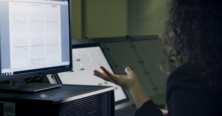 A woman sitting at a desktop computer.