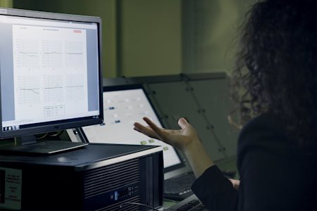 A woman sitting at a desktop computer.