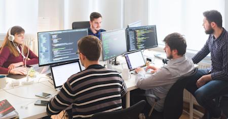 IT team working on patch scanning, system monitoring and coding.