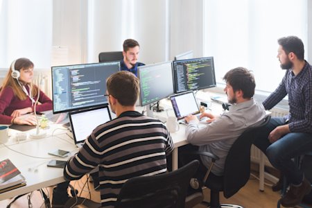 IT team working on patch scanning, system monitoring and coding.