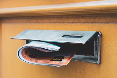 Mailbox with a newspaper sticking out of it