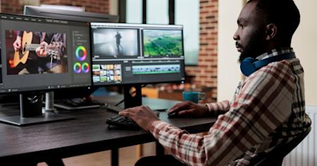 A man using Splashtop remote desktop software and viewing the multiple monitors of the remote computer on his local multi monitor display.