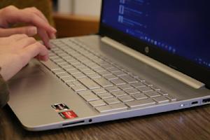 Hands typing on a laptop.