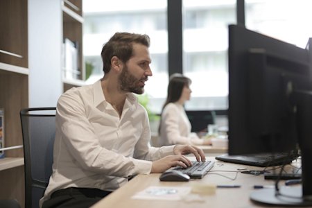 An IT admin working at his office computer.