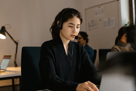 An IT tech support worker at their desk.