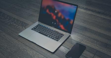 A laptop and smartphone on a desk.