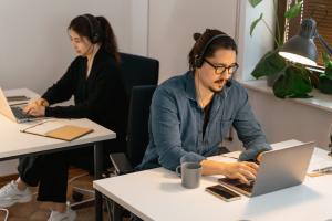 Two IT technicians working at their computers.