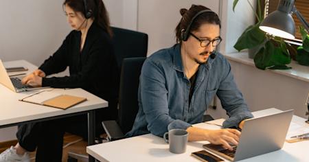 Two IT technicians working at their computers.