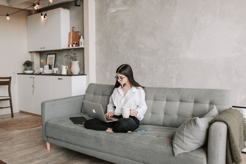 A woman working remotely by using a laptop.