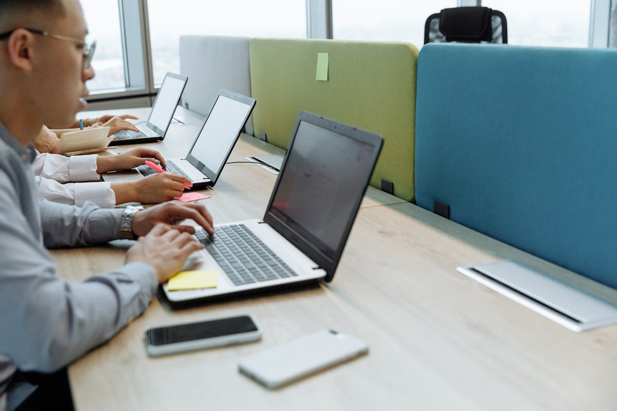 A group of employees using their computers in an office.