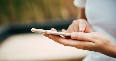 A person typing on a smartphone.