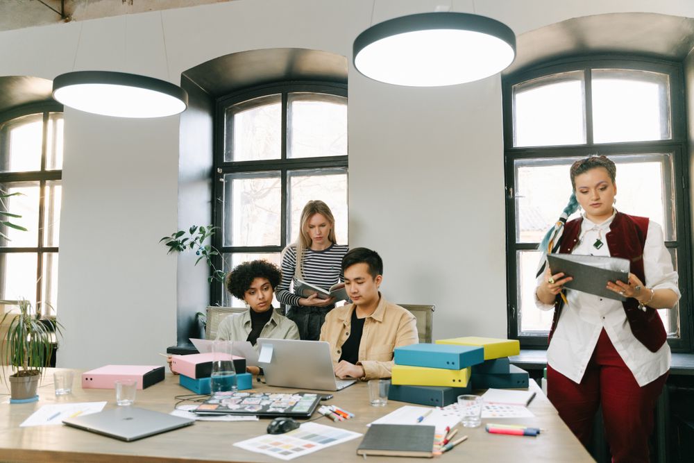 People working in a small business office with their laptops.
