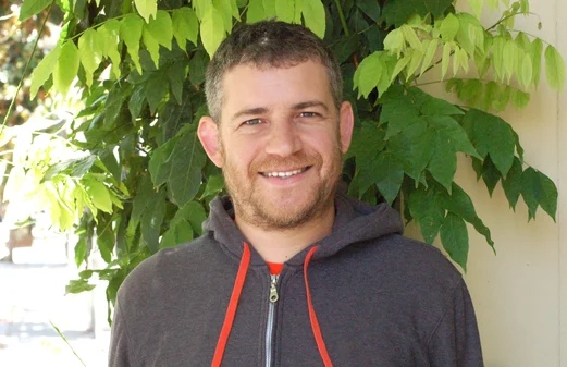 A photograph of Aren smiling at the camera