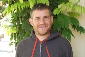 A photograph of Aren smiling at the camera