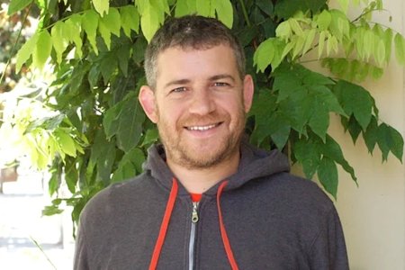 A photograph of Aren smiling at the camera