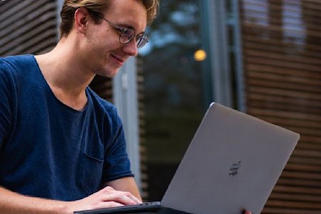 IT manager utilizing a laptop and remote desktop software for MSP unmanaged device support