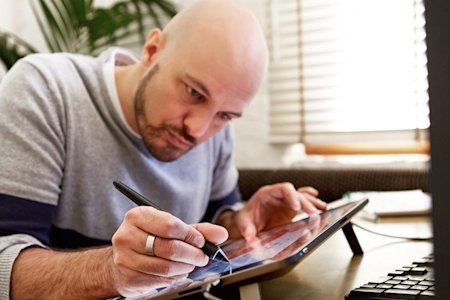 Man using a Wacom tablet connected to a computer via Splashtop remote desktop