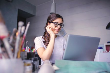 A woman working remotely using a Chromebook.