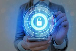 Person holding a mobile phone with a circular lock security image projected above it