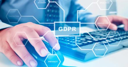 Professional using a computer with GDPR-related terms overlayed, symbolizing data protection and compliance.