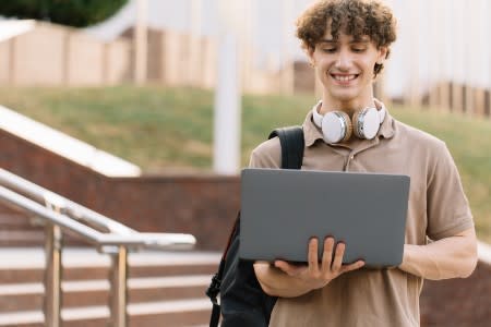 Student using laptop to remotely access a computer 