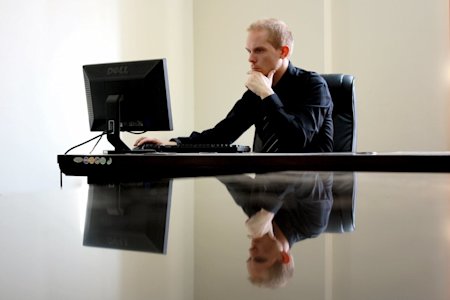 A business professional working on a Windows computer.