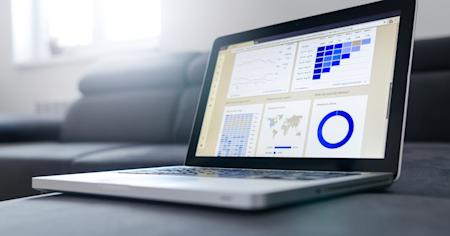 A laptop with the screen displaying analytics charts