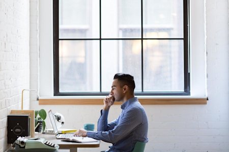 A business professional working on a computer.