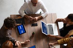 A group of coworkers using third-party apps on their devices.