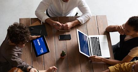 A group of coworkers using third-party apps on their devices.