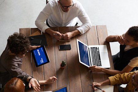 A group of coworkers using third-party apps on their devices.
