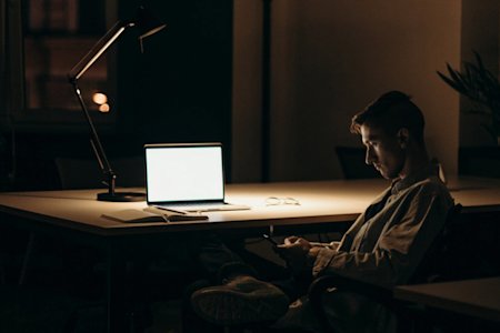 Professional working late using Splashtop on laptop