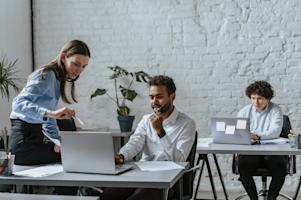 A group of coworkers at their desks working on computers.