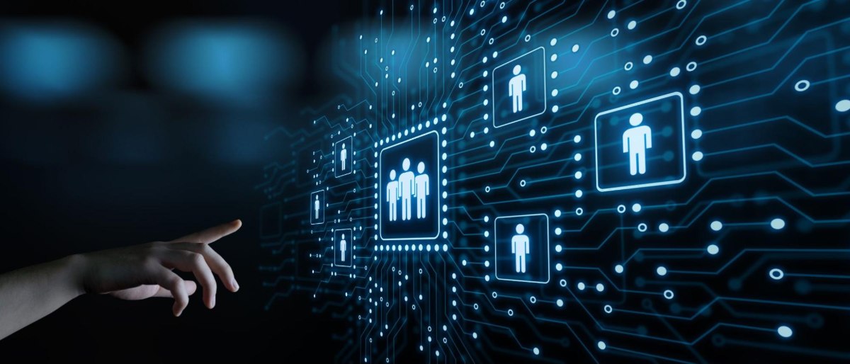 A hand reaching out to a digital board showing symbols of people connected across a circuit board-like design