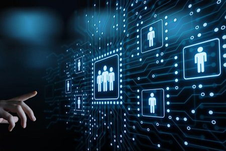 A hand reaching out to a digital board showing symbols of people connected across a circuit board-like design