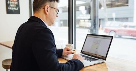 A man working on a laptop.