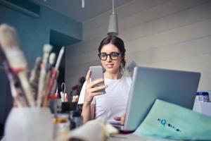 A woman receiving a two-factor authentication code on her phone while logging into Splashtop remote access software